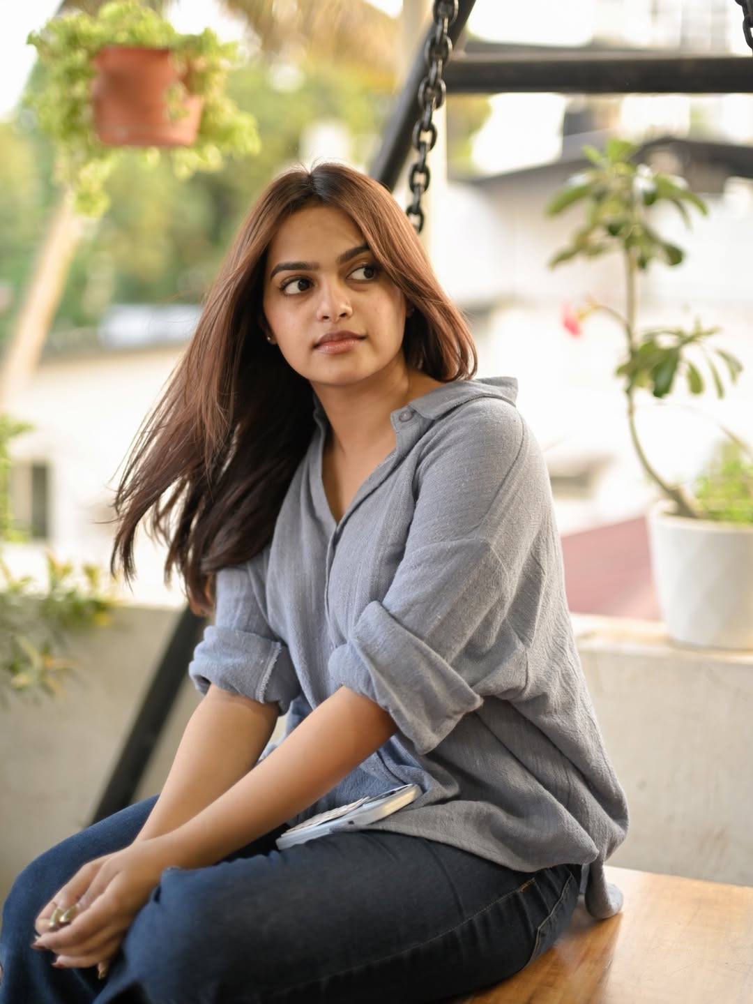 Gopika Ramesh in grey shirt thoughtful pose