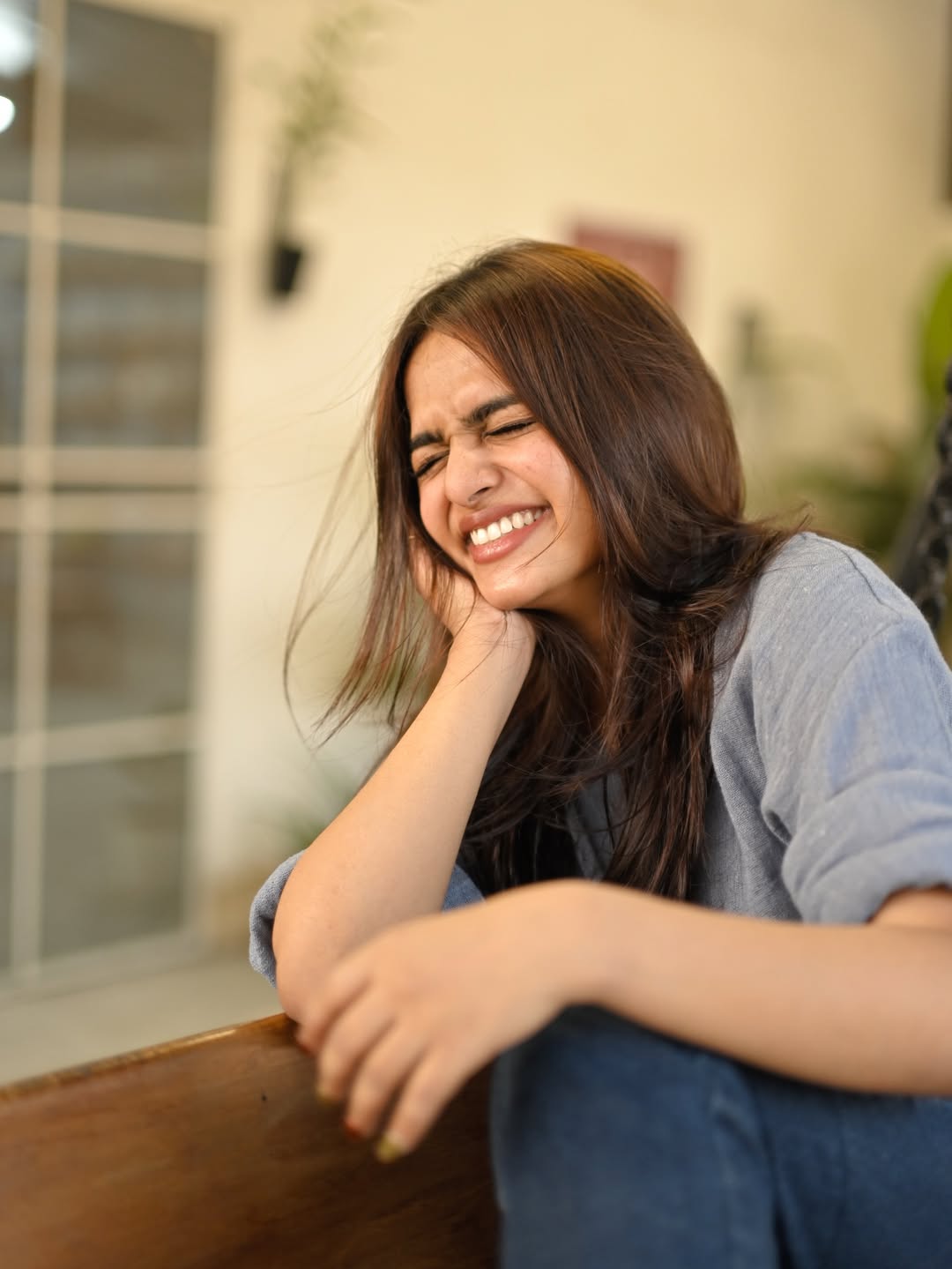 Gopika Ramesh smiling casually in grey shirt