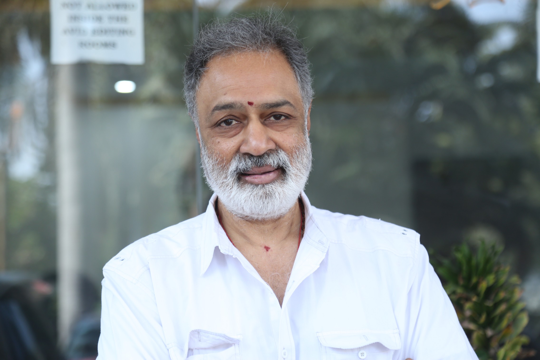 K. L. Damodar Prasad stylish salt-and-pepper look outdoors