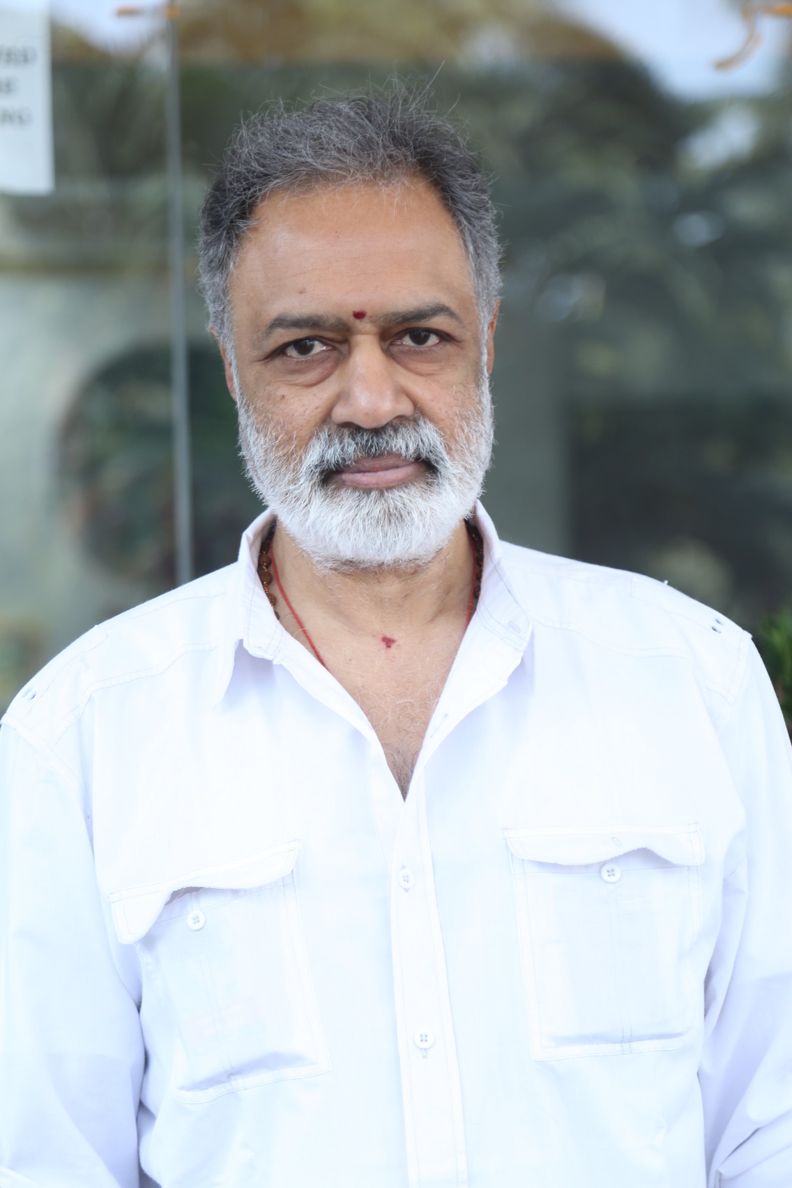 K. L. Damodar Prasad elegant portrait with grey hairstyle