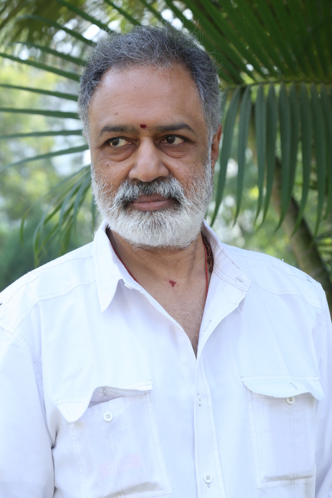 K. L. Damodar Prasad posing in stylish outfit