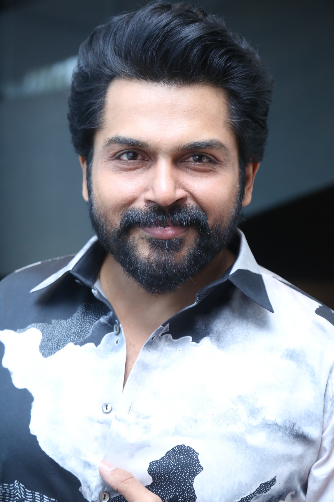 Karthi rocking bold patterned shirt with confident smile