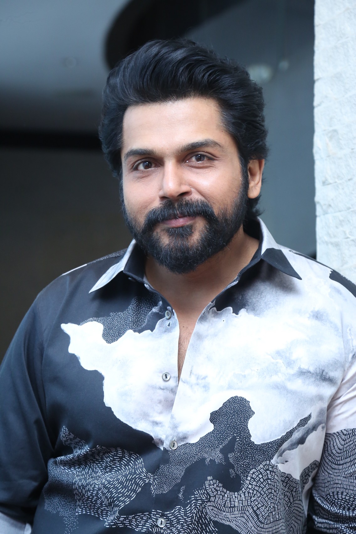 Karthi dressed in crisp shirt with bold attitude