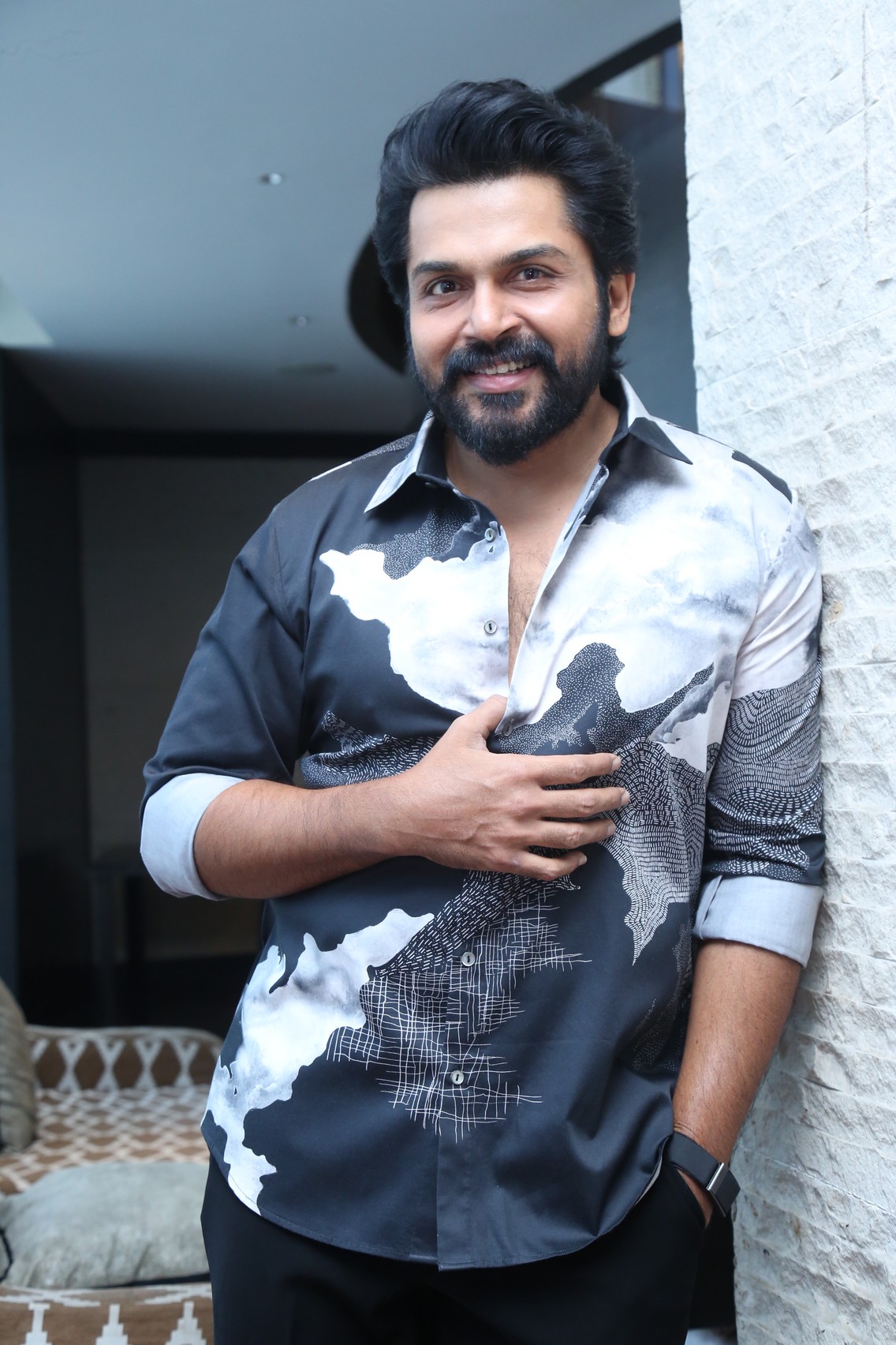 Karthi smiling confidently in stylish casual shirt