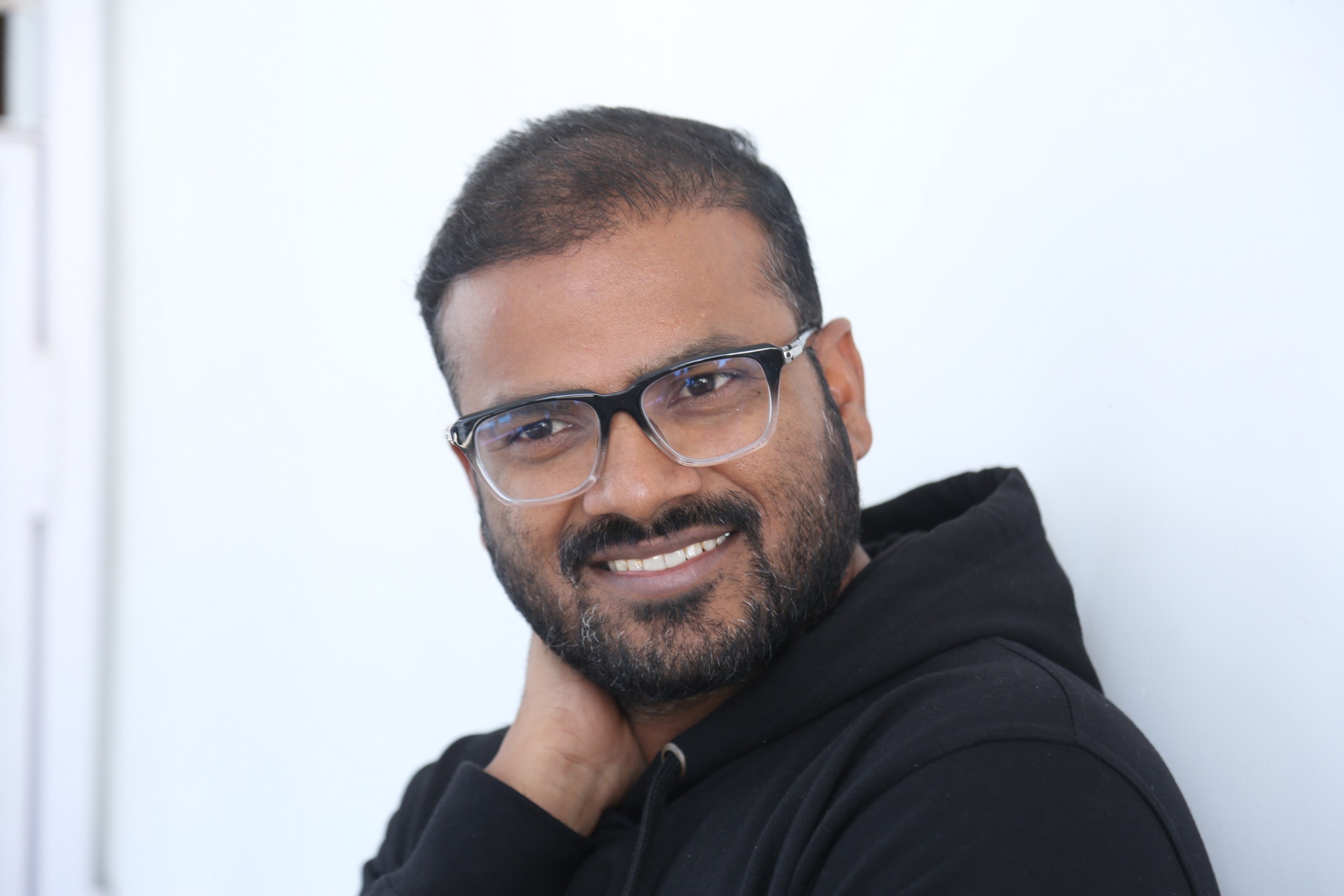 Muralikanth Devasoth smiling confidently in casual wear