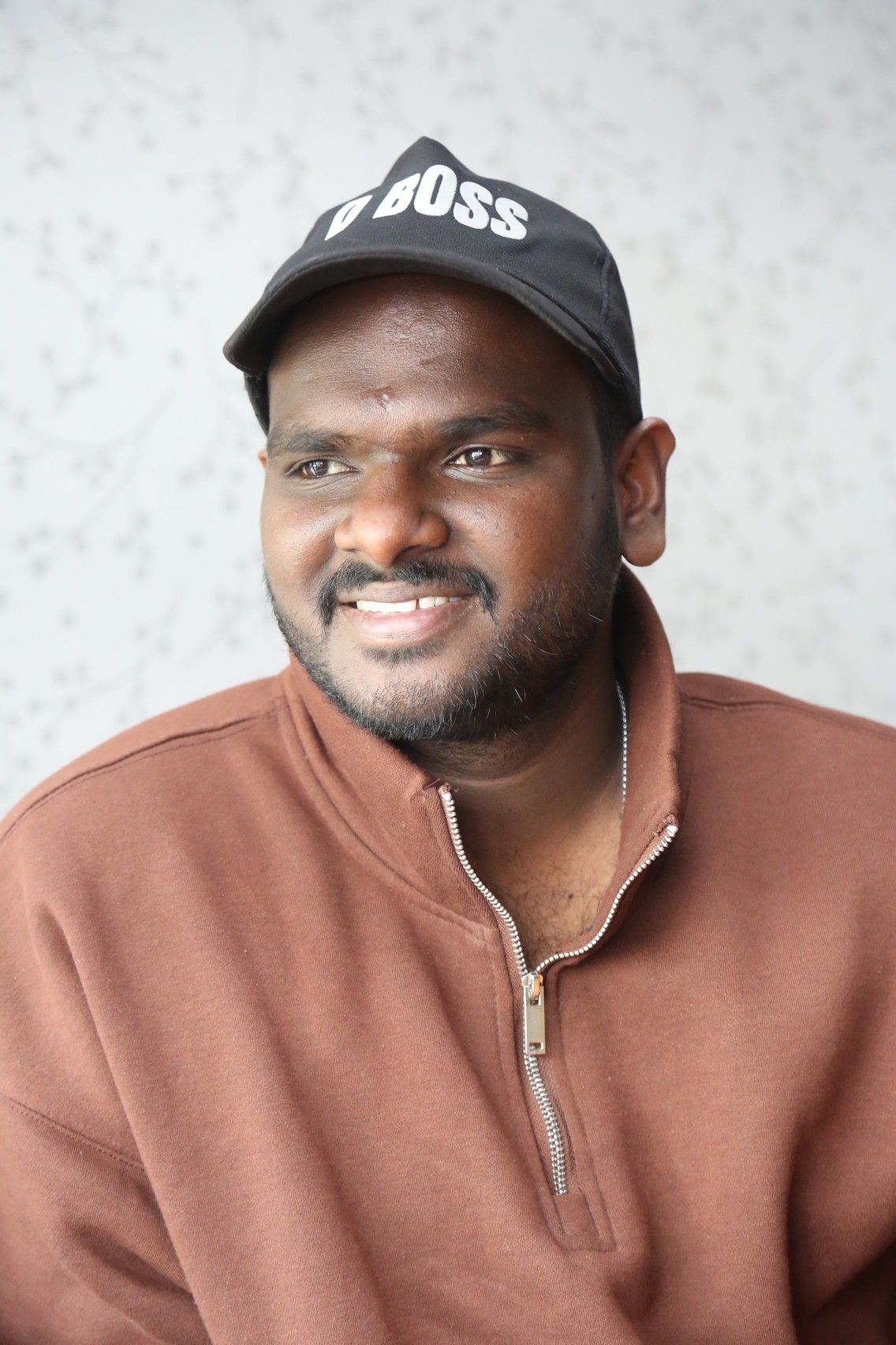 Nanduri Emmanuel confident smile in smart casual outfit