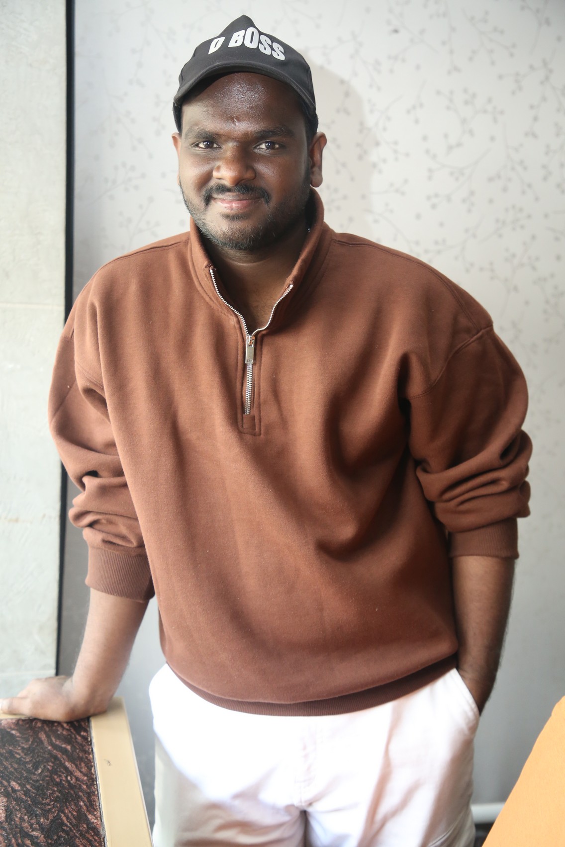 Nanduri Emmanuel sharp hoodie style with D Boss cap