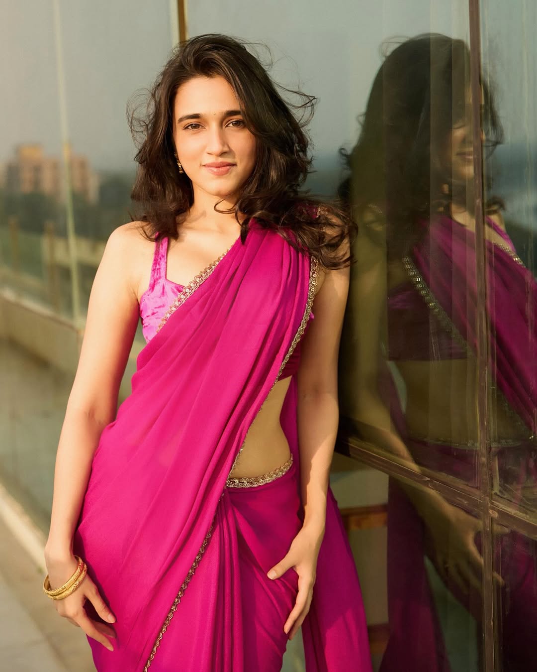 Nuveksha glowing in pink saree with golden elegance