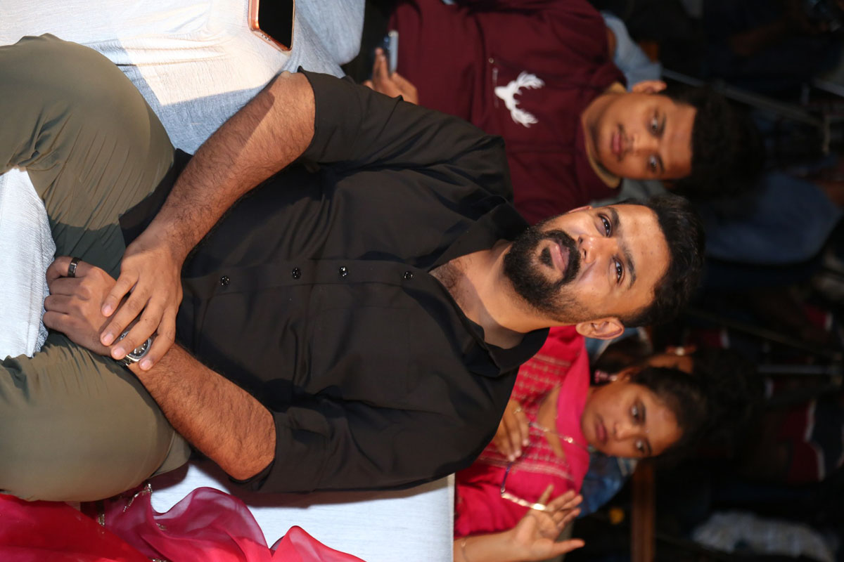 Tharun Bhascker seated at event venue