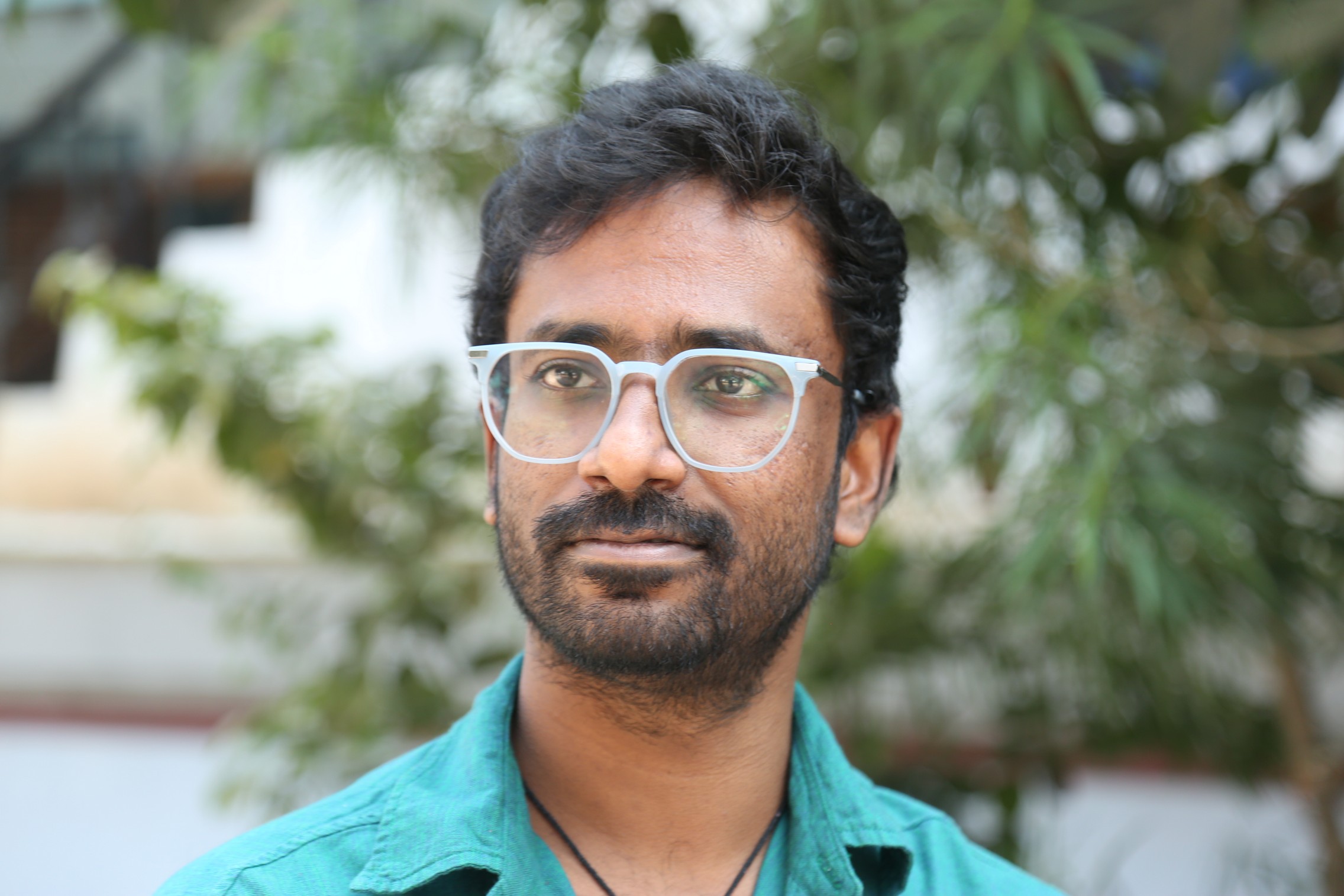 Praneeth Prattipati confident look with stylish glasses