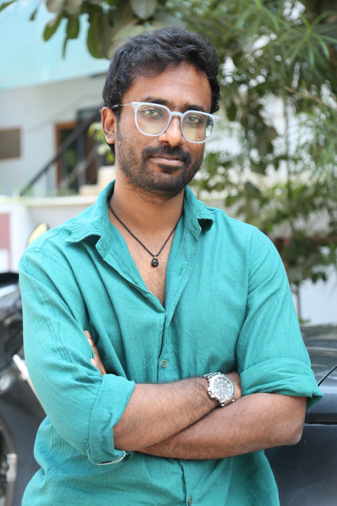 Praneeth Prattipati teal shirt look with glasses