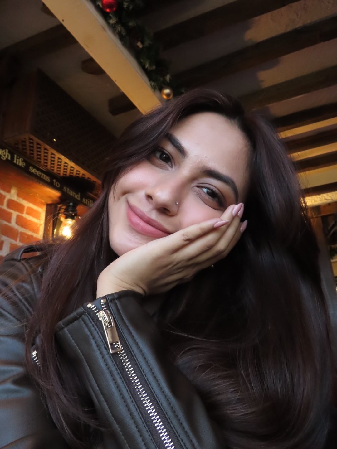 Reem Sameer Shaikh smiling in chic casual jacket indoors