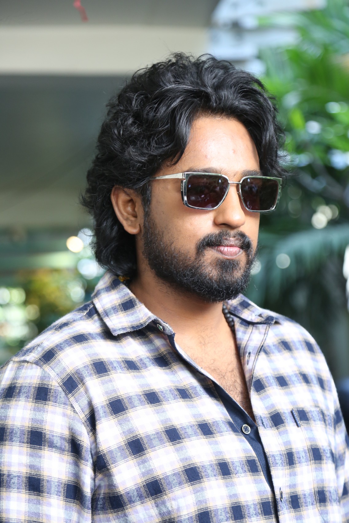 Roshan Kanakala in plaid shirt and cool shades