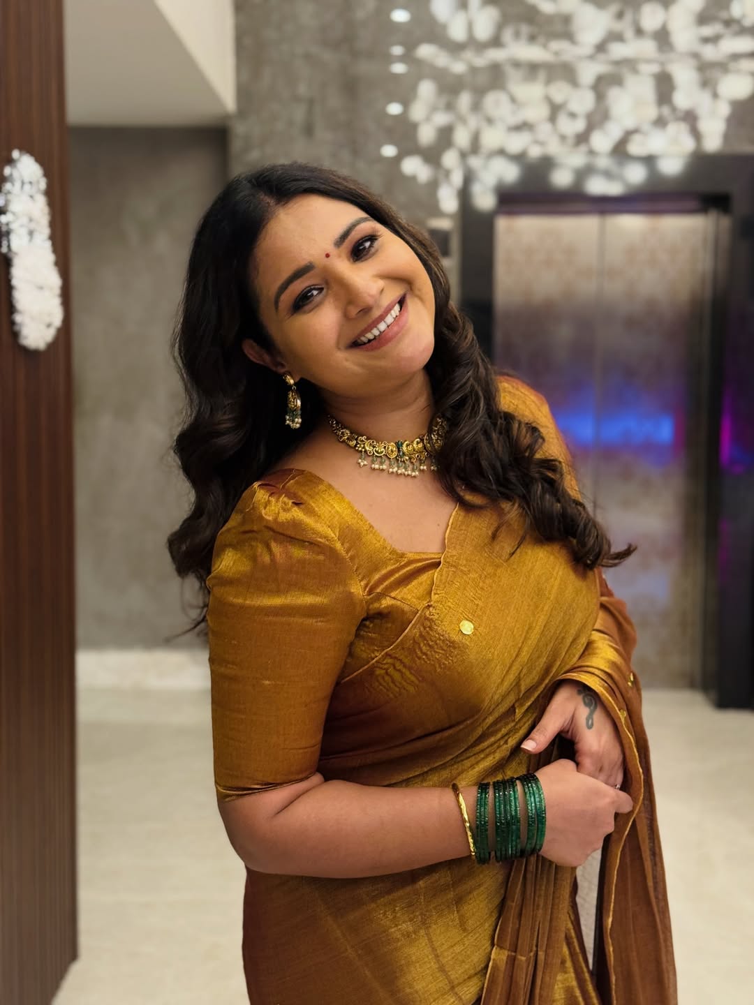 Sharanya Turadi shimmering golden saree with graceful poise