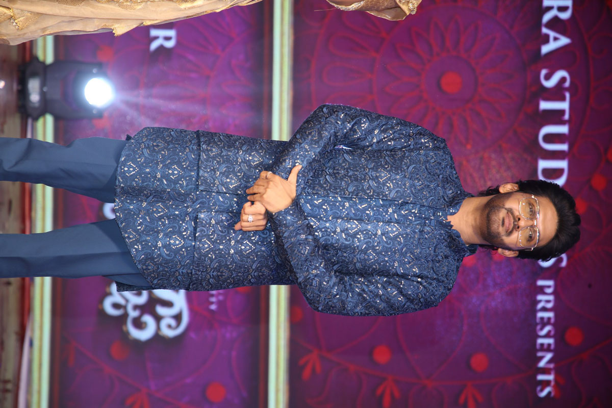 Naveen Polishetty posing confidently in stylish blue attire