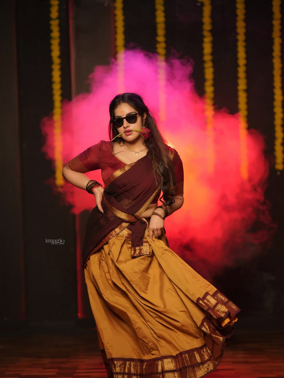 Malavika styled in saree holding rose confidently