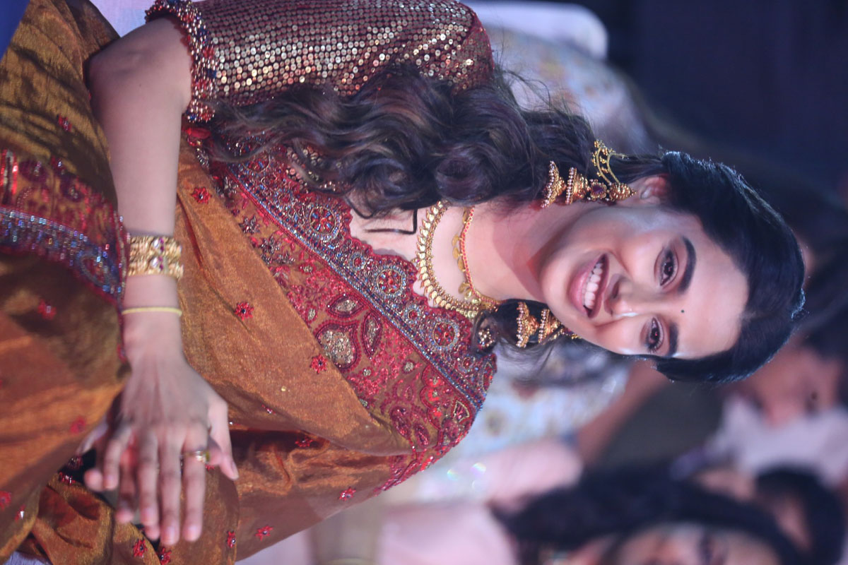 Meenakshi Chaudhary seated and smiling