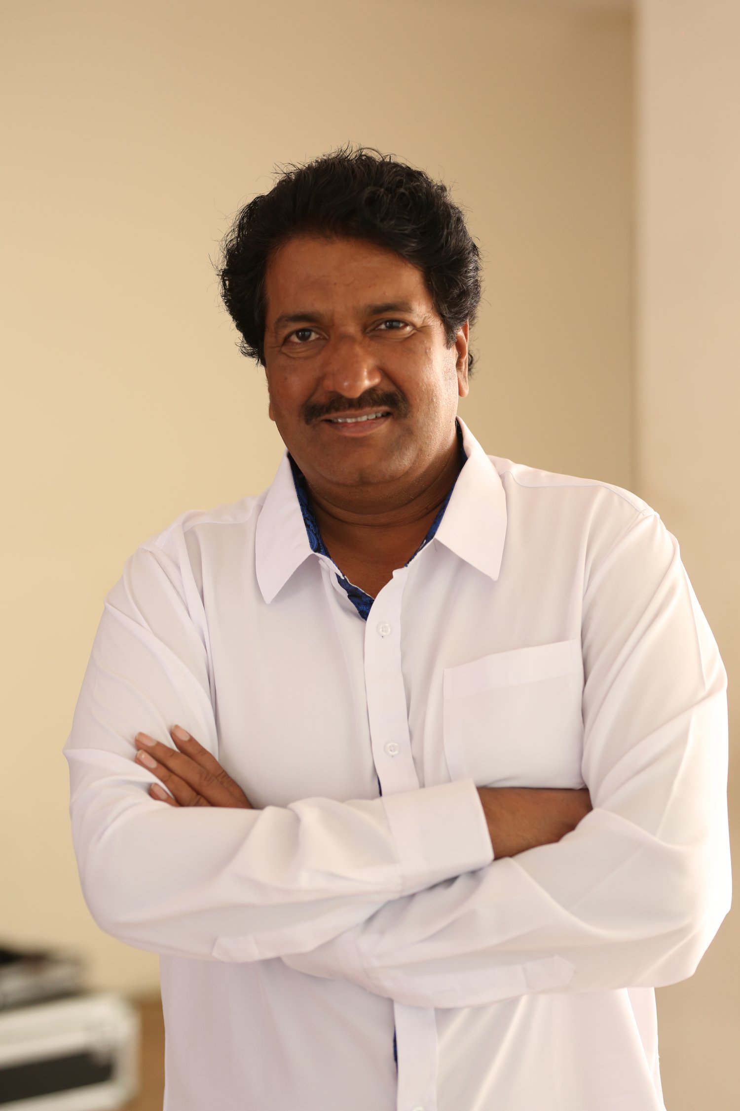 Anil Sunkara posing confidently in sharp formal attire