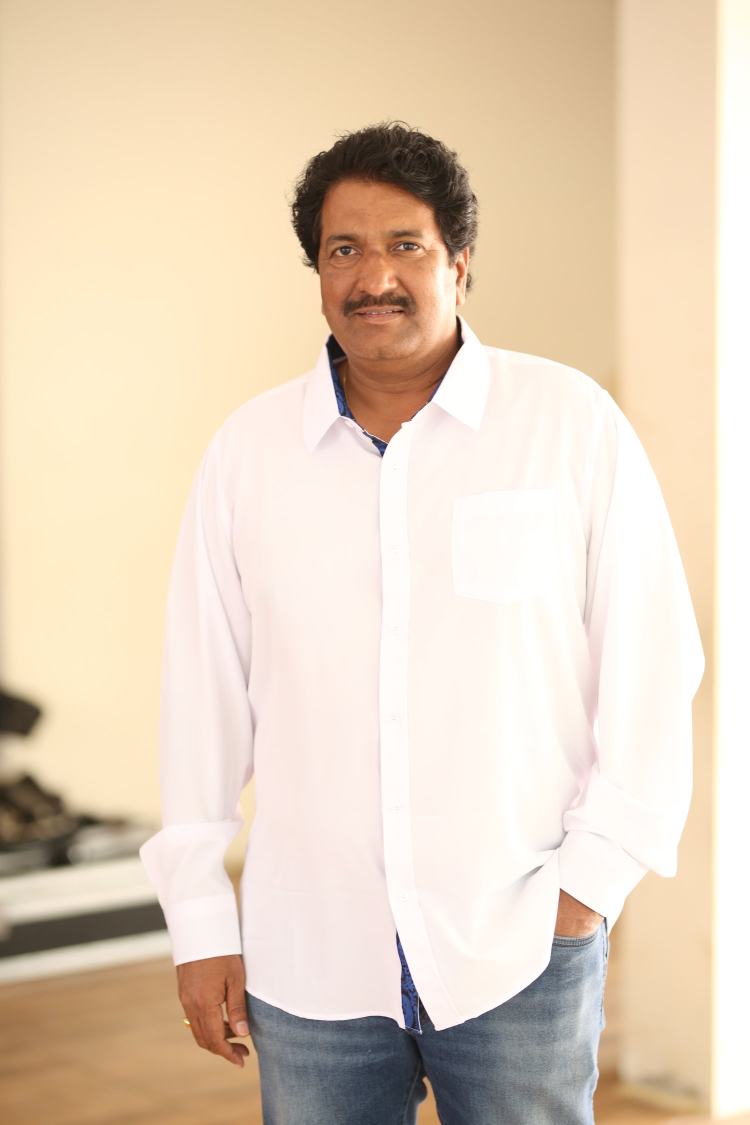 Anil Sunkara smiling confidently in crisp formal outfit