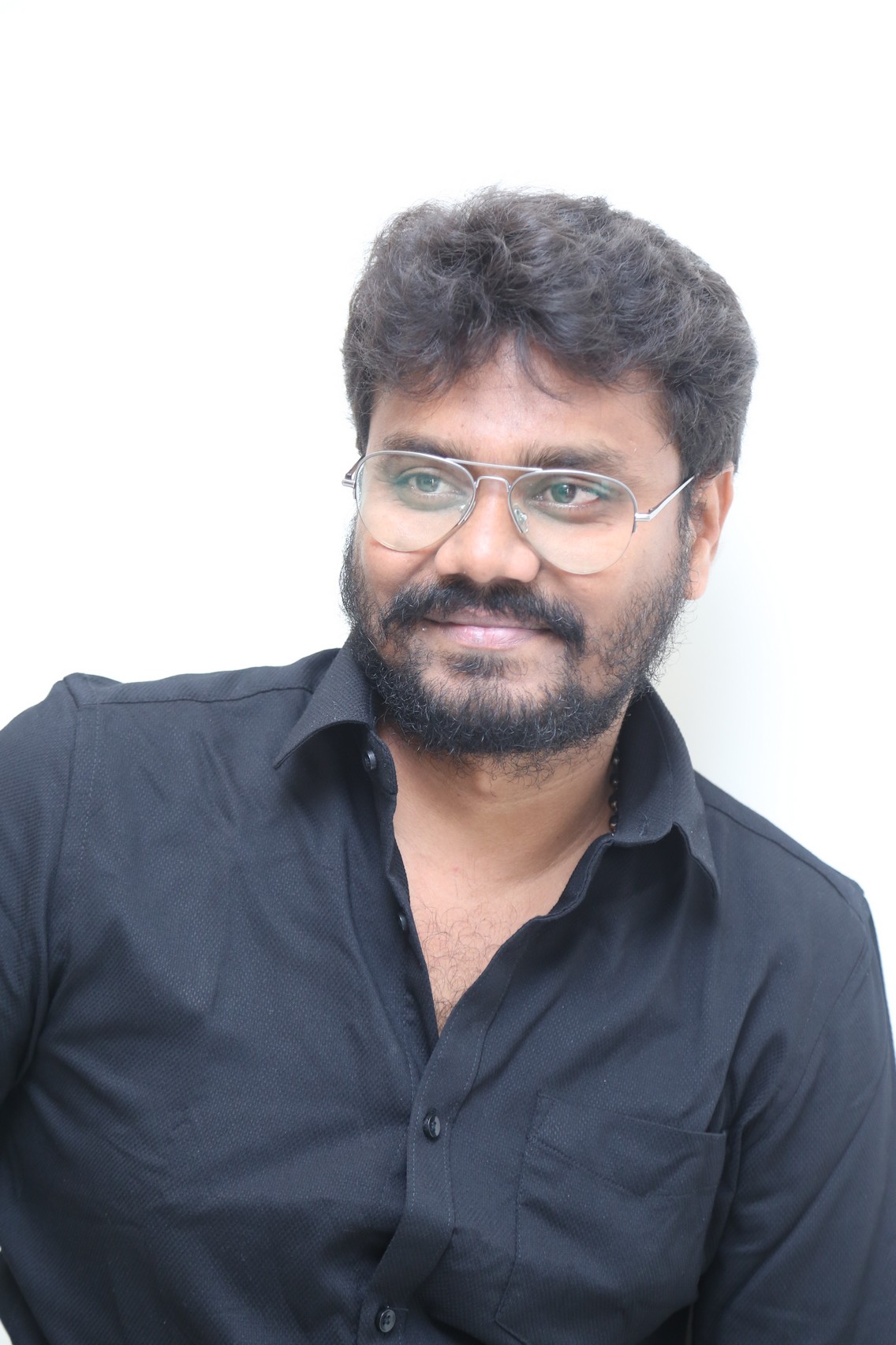 AR Sajeev in glasses and black shirt style