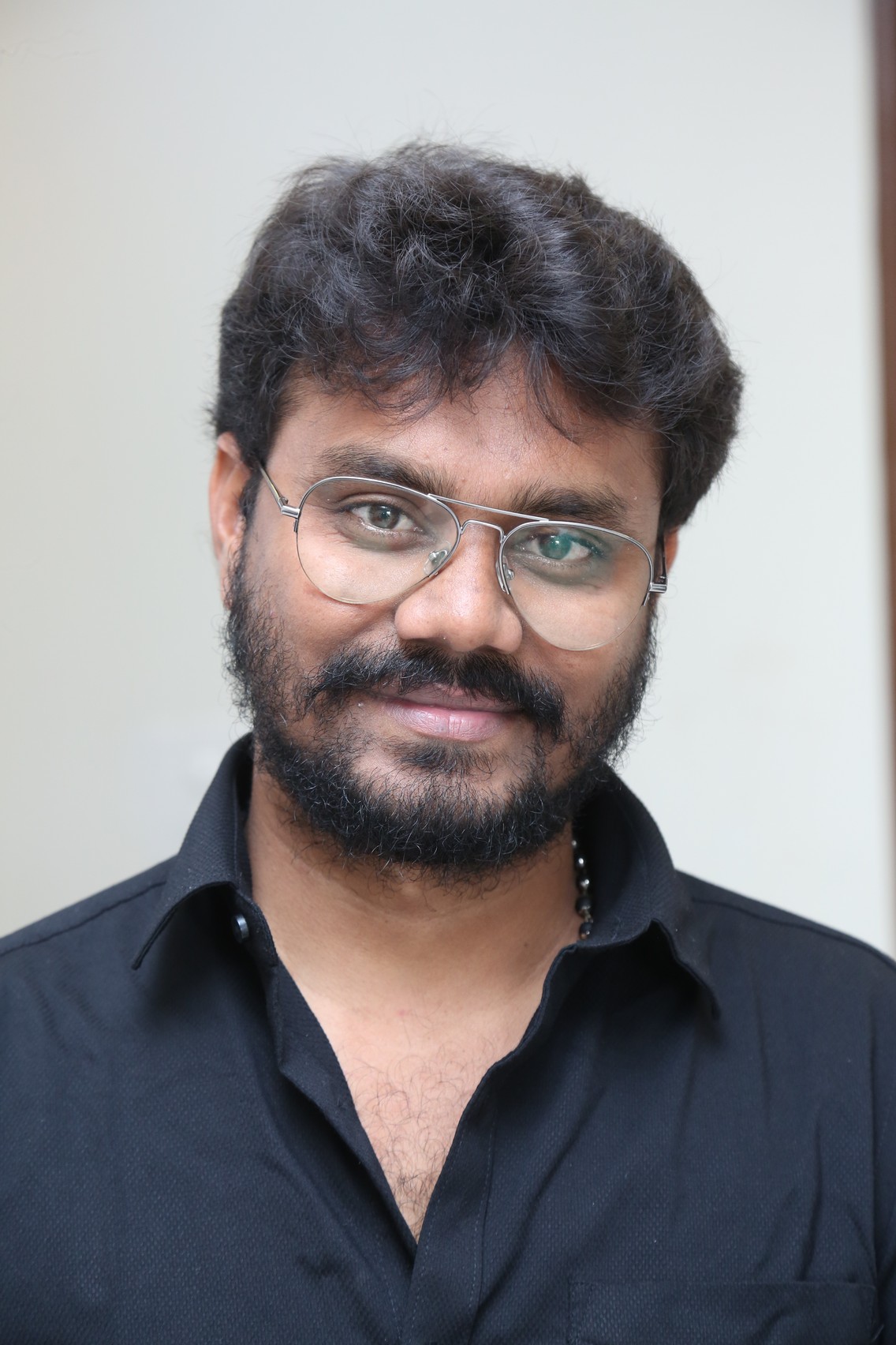 AR Sajeev sporting beard glasses and black shirt