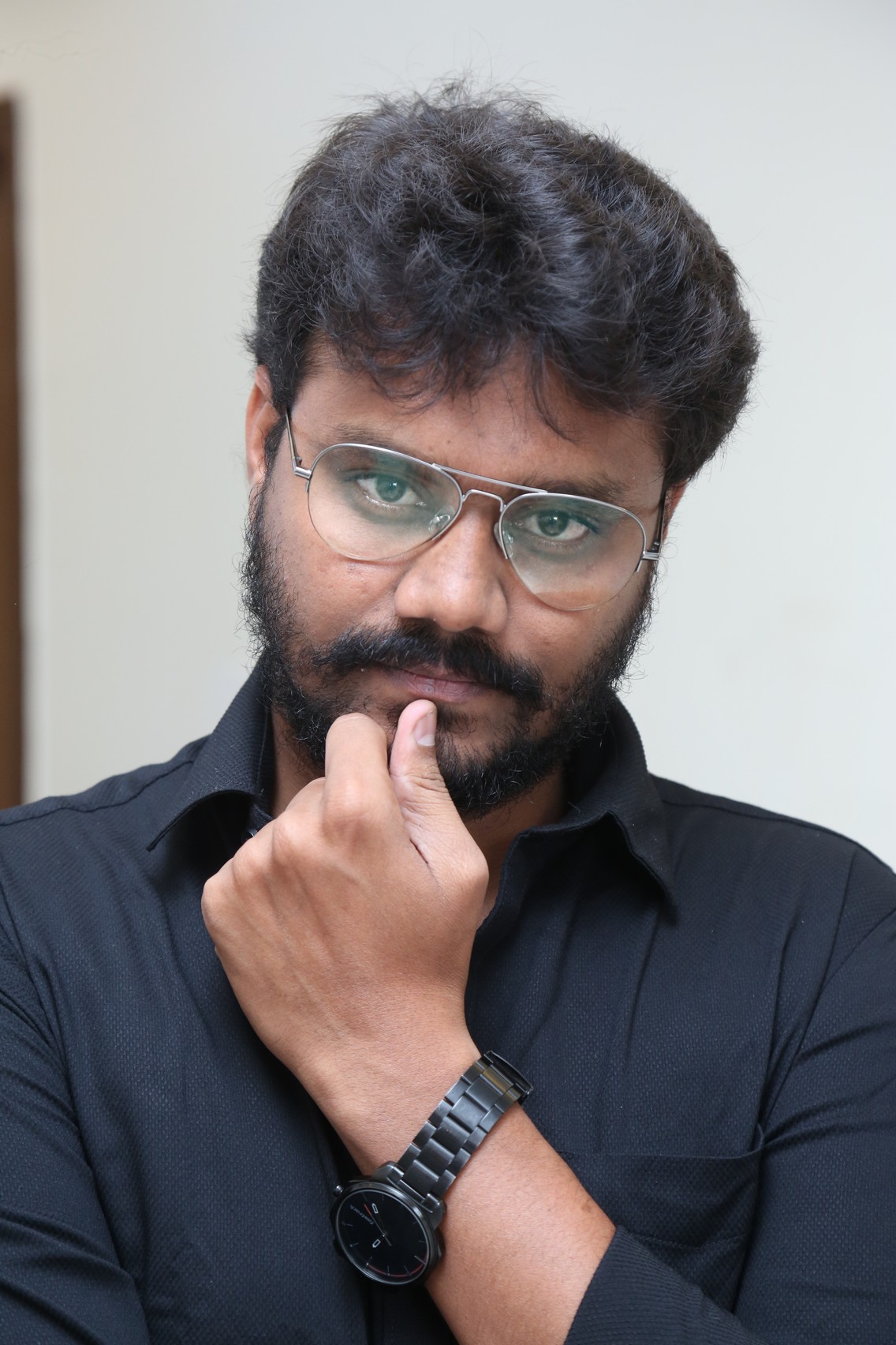 AR Sajeev thoughtful pose in classic black attire