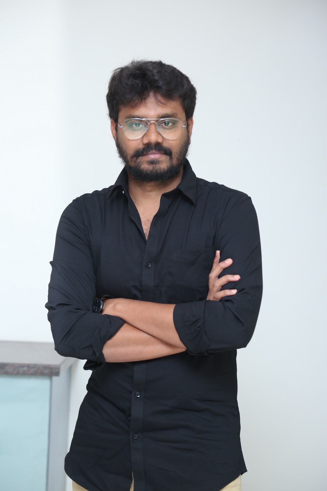 AR Sajeev professional black shirt confident stance