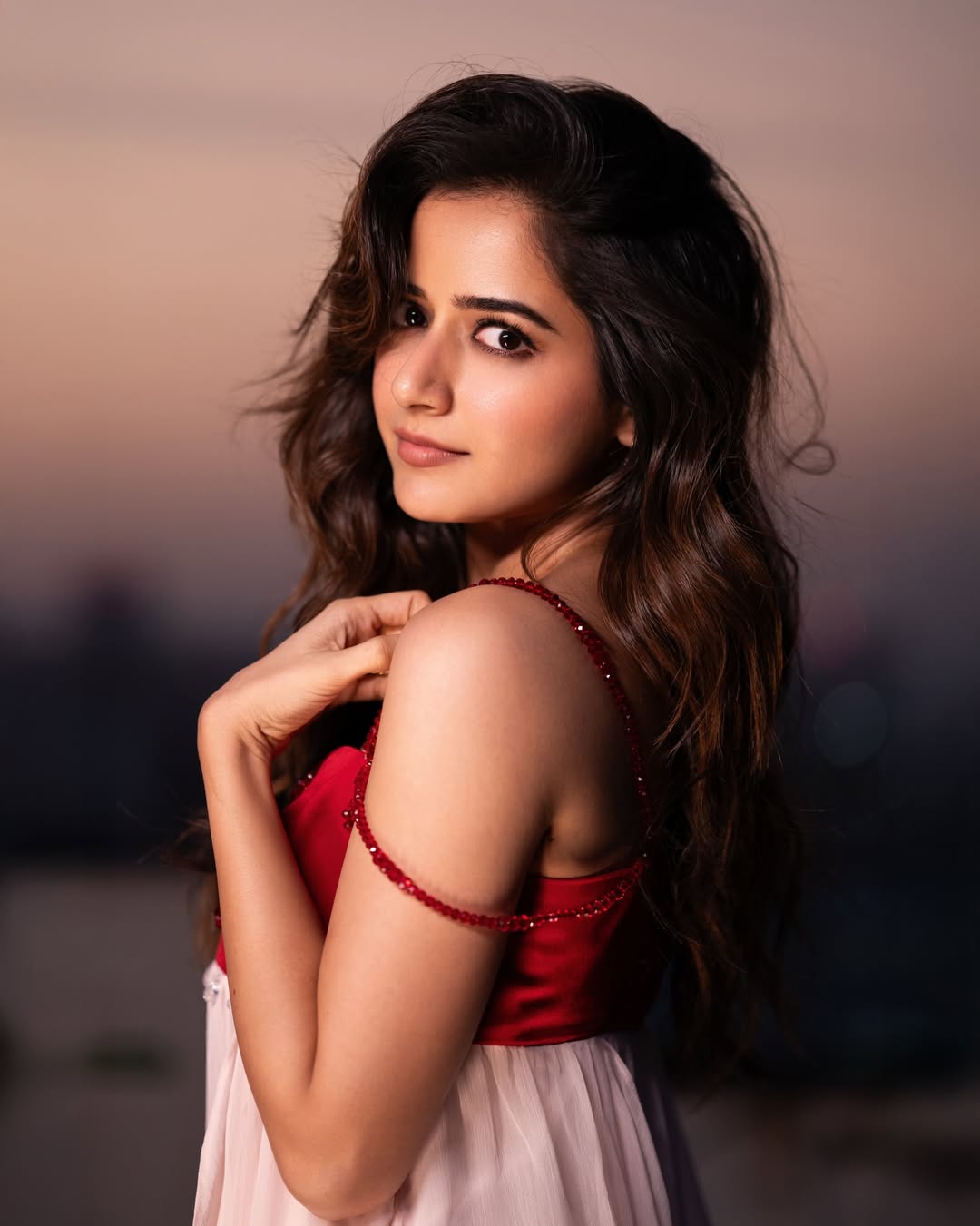 Ashika Ranganath red dress with confident elegant attitude
