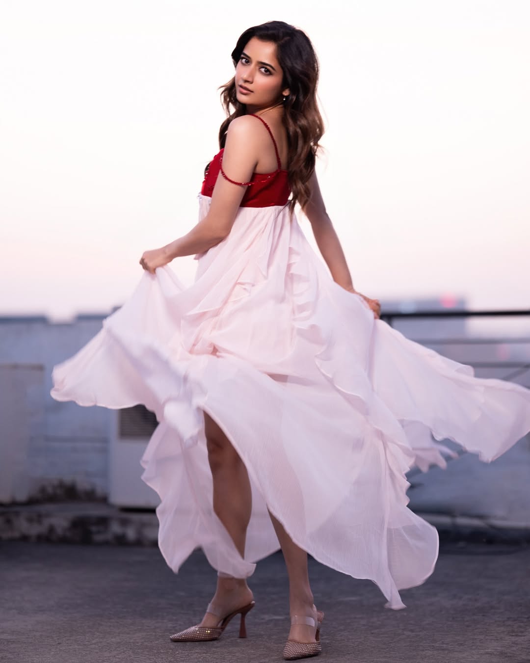 Ashika Ranganath owns rooftop runway in stylish red elegance