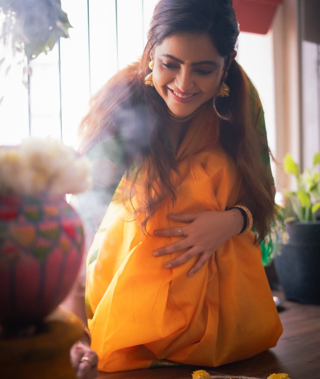 Athulya Ravi shines in vibrant orange traditional saree