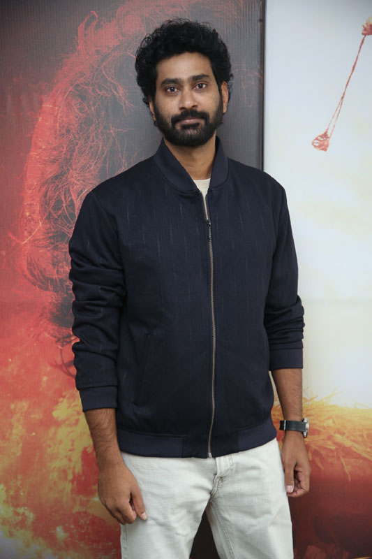 Thiruveer posing confidently for media