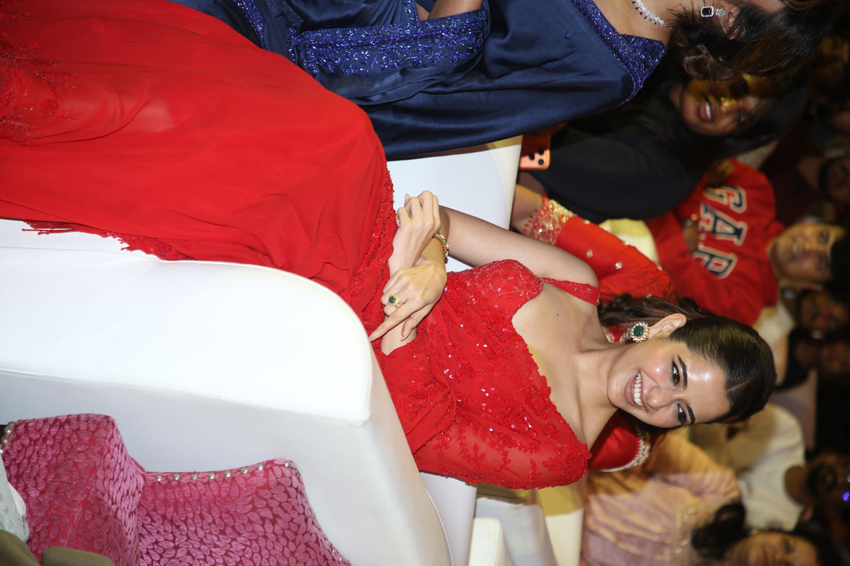 Ashika Ranganath seated laughing at movie pre release event