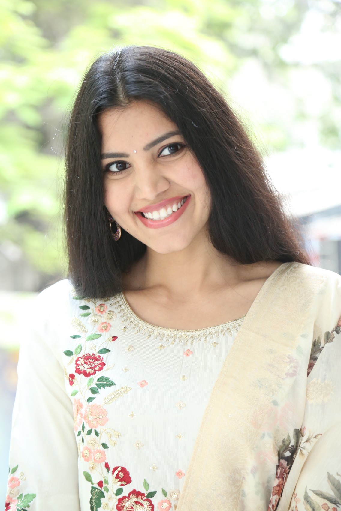 Mounika Reddy smiling in elegant traditional floral attire