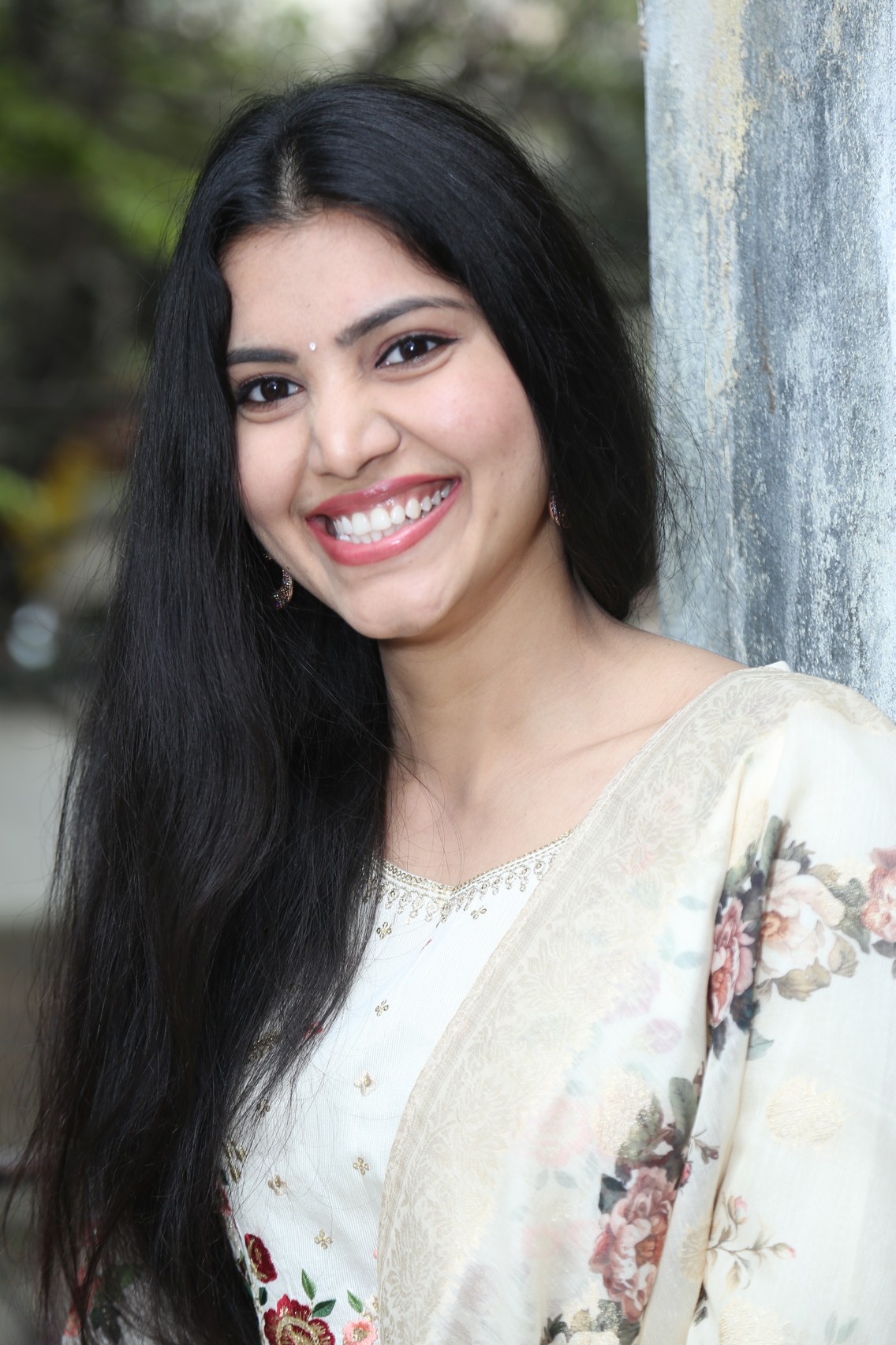 Mounika Reddy posing gracefully in elegant floral outfit