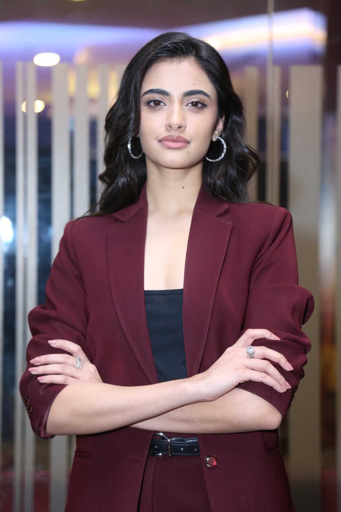 Rhea Singha striking powerful pose in maroon blazer