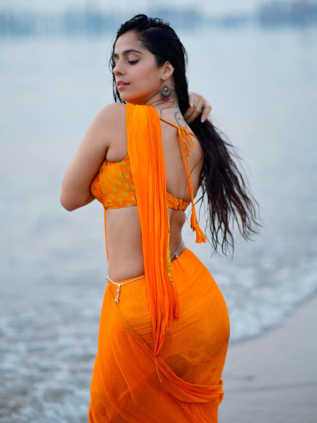 Rose Sardana stuns in vibrant orange beach look