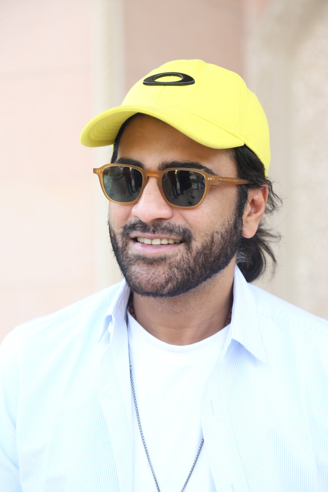 Sharwanand sporting yellow cap and shades confidently