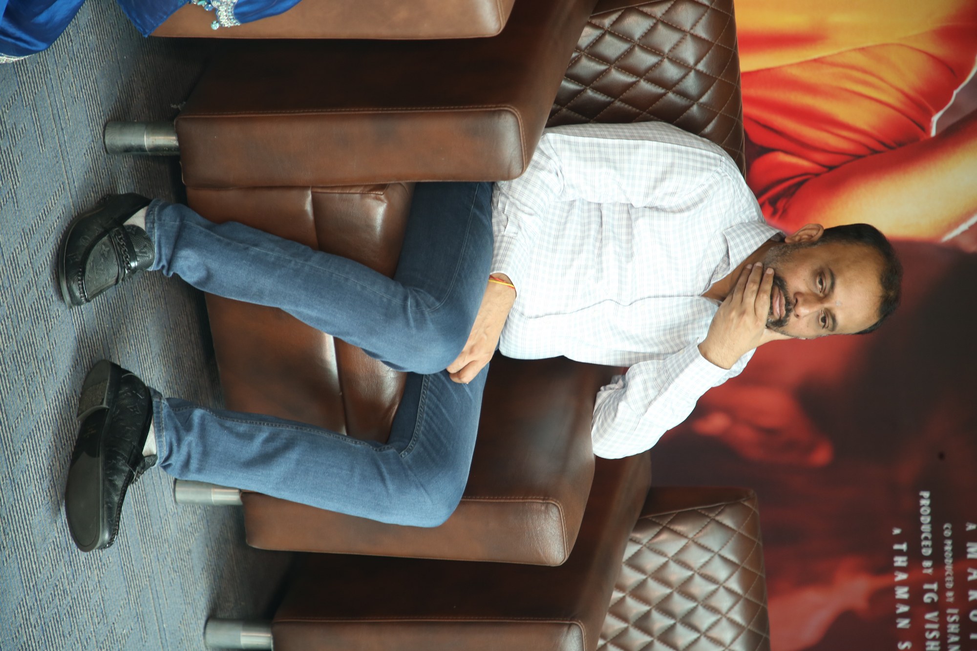 TG Vishwa Prasad seated on stage at The Raja Saab event