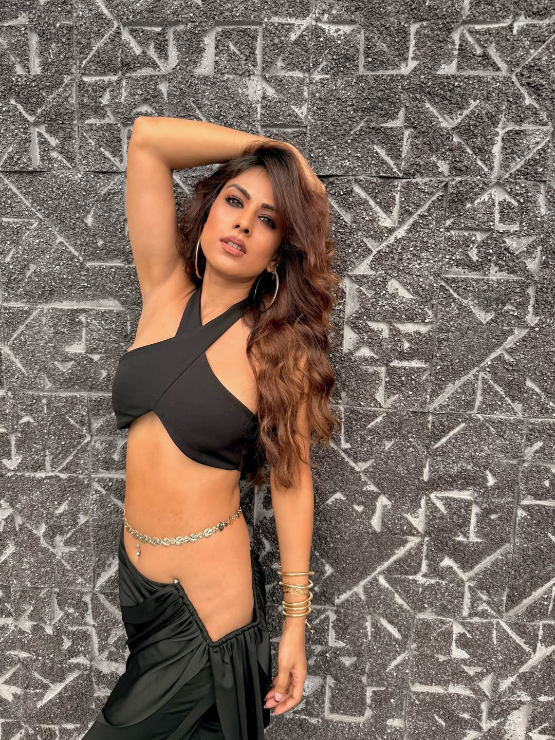 Nia Sharma posing in edgy black outfit with confident expression