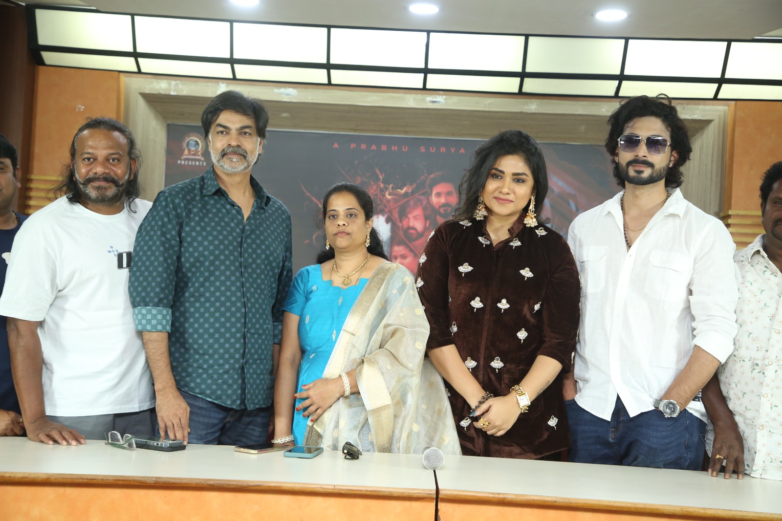 Cast sharing light moment on stage