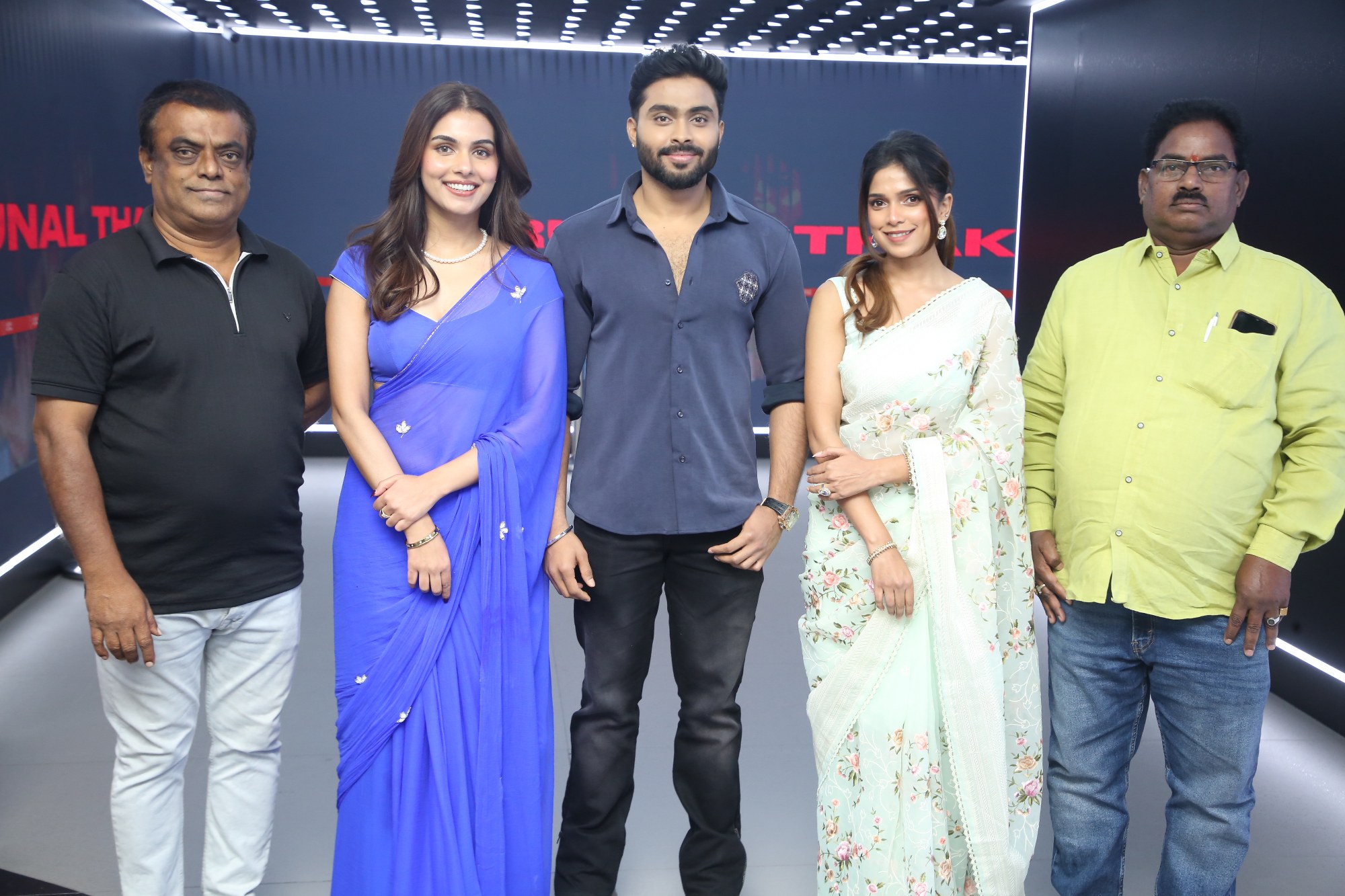 Cast and distributor posing together for media
