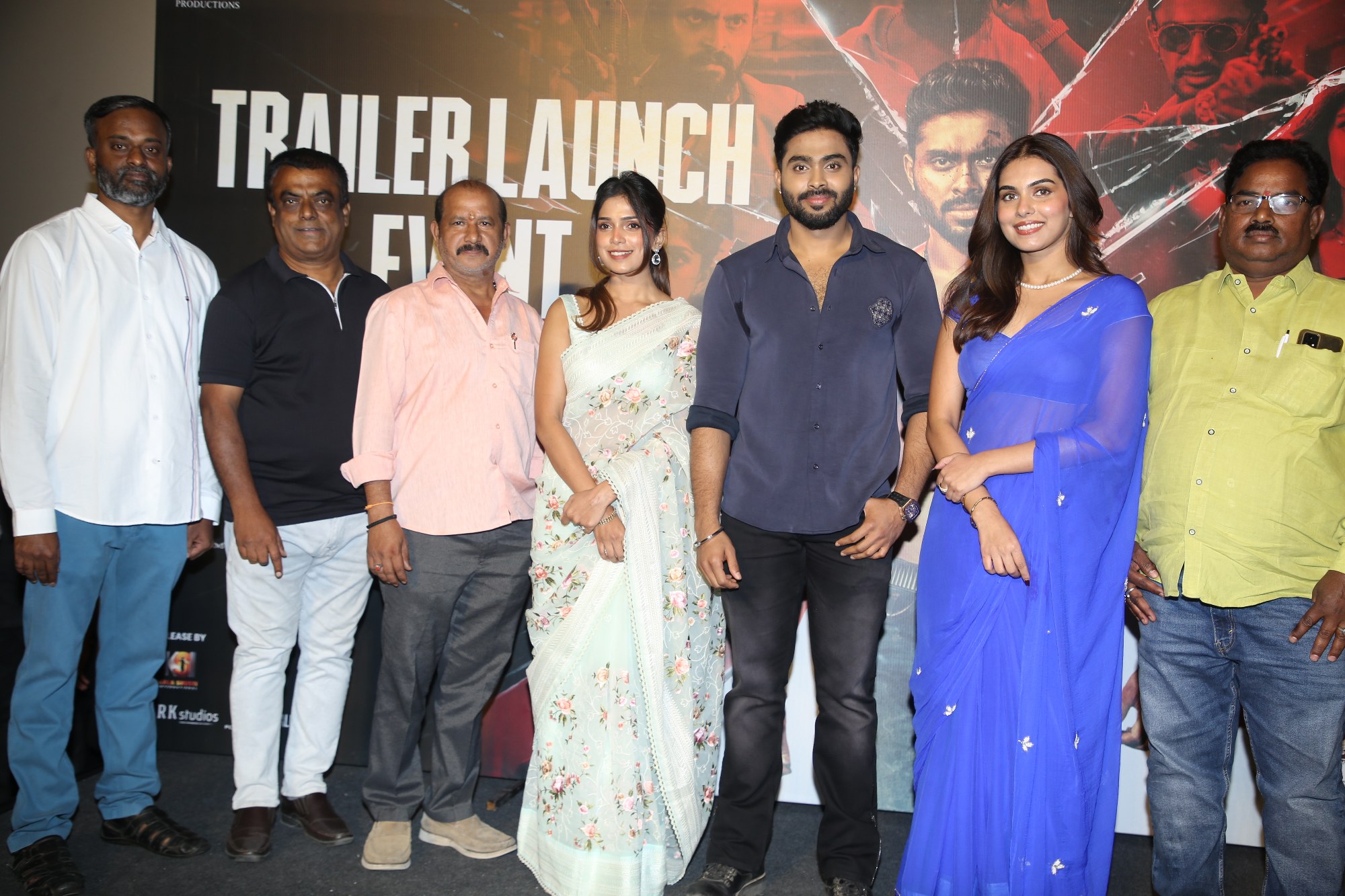 Full team posing together on stage