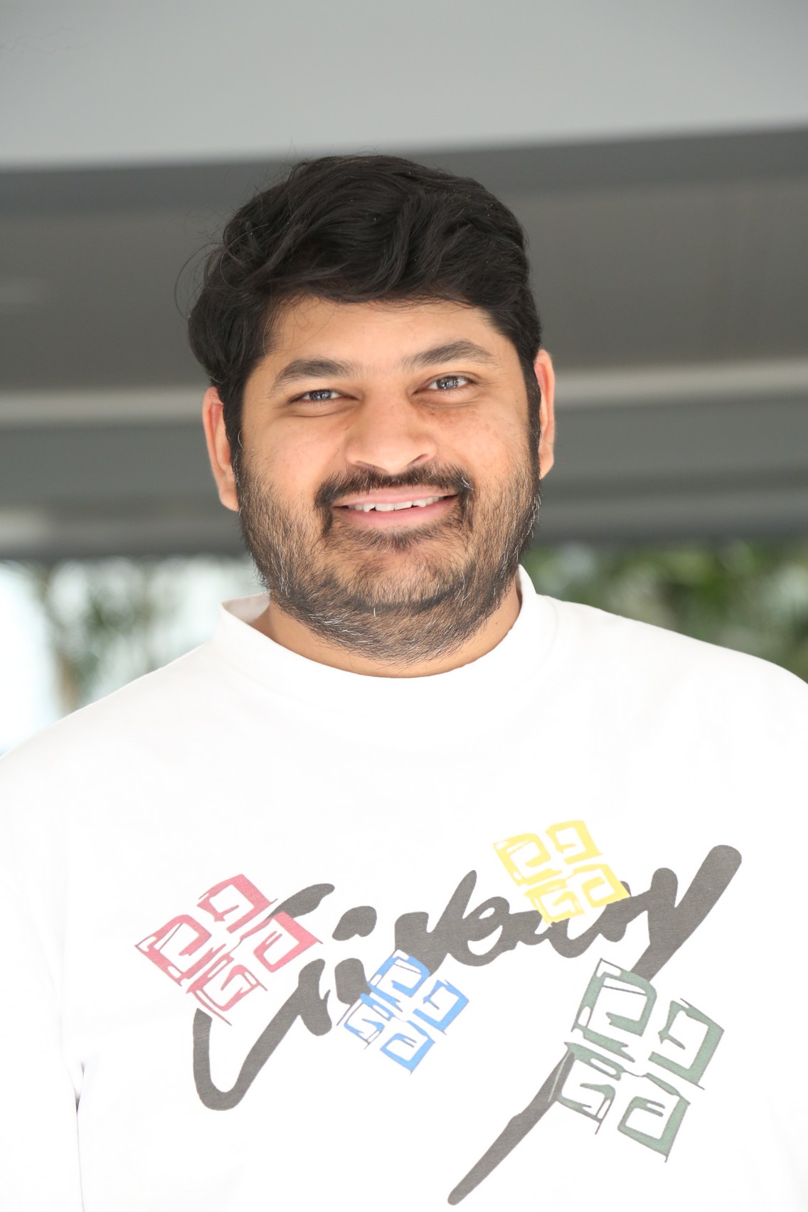 Dheeraj Mogilineni in white tee casual style