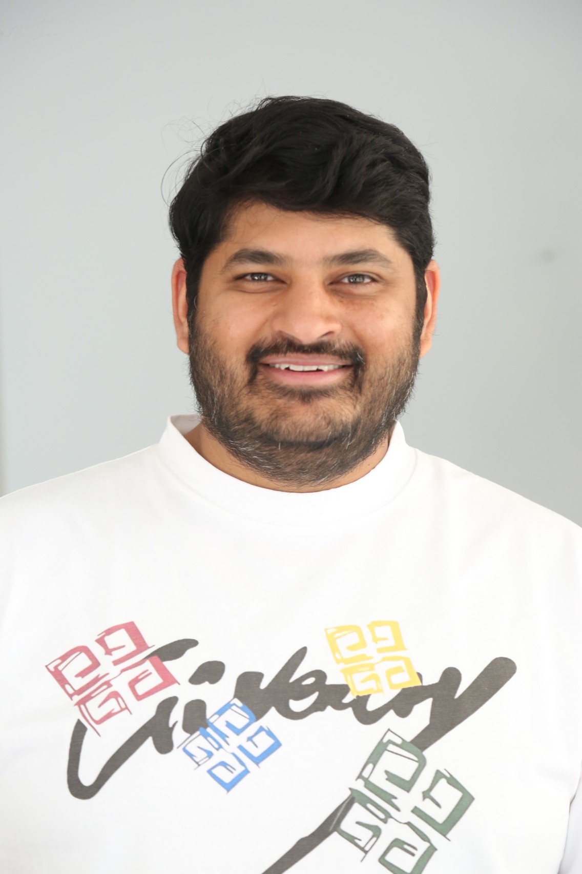 Dheeraj Mogilineni smiling in casual outfit