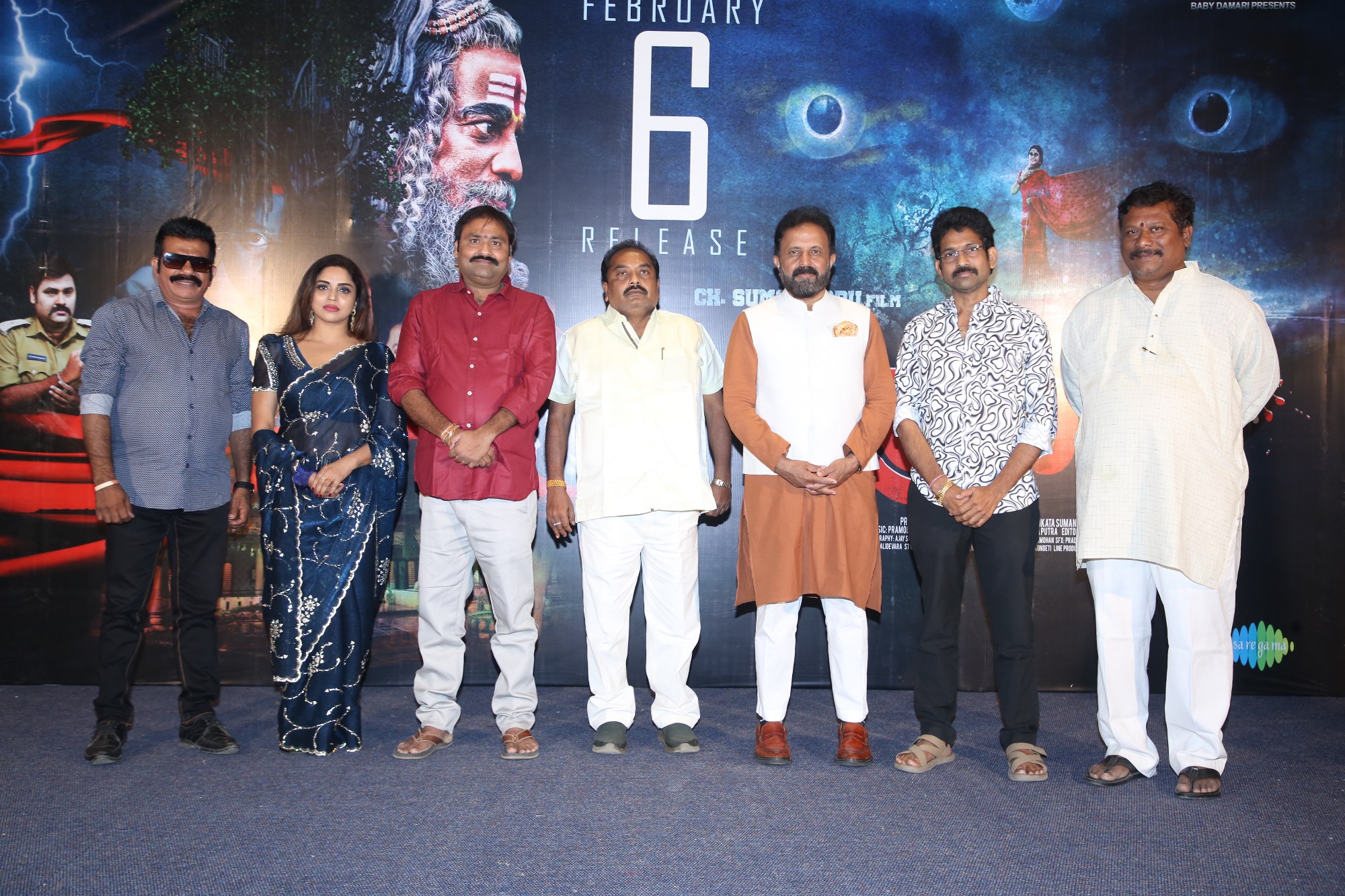 Film team gathered under stage lights