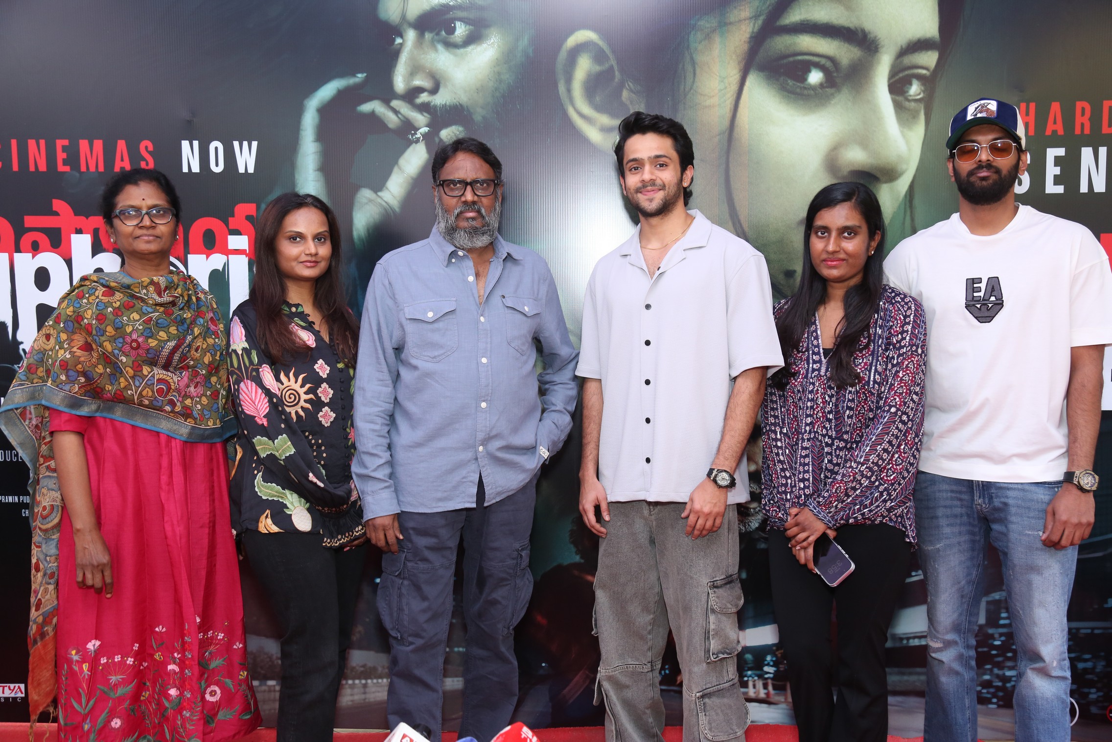 Cast posing with joyful expressions