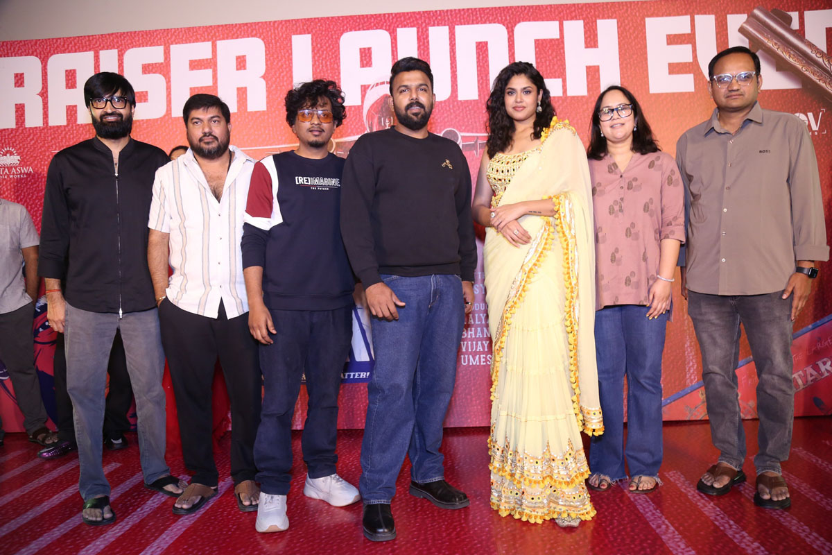 Film team including cast and producers pose on stage