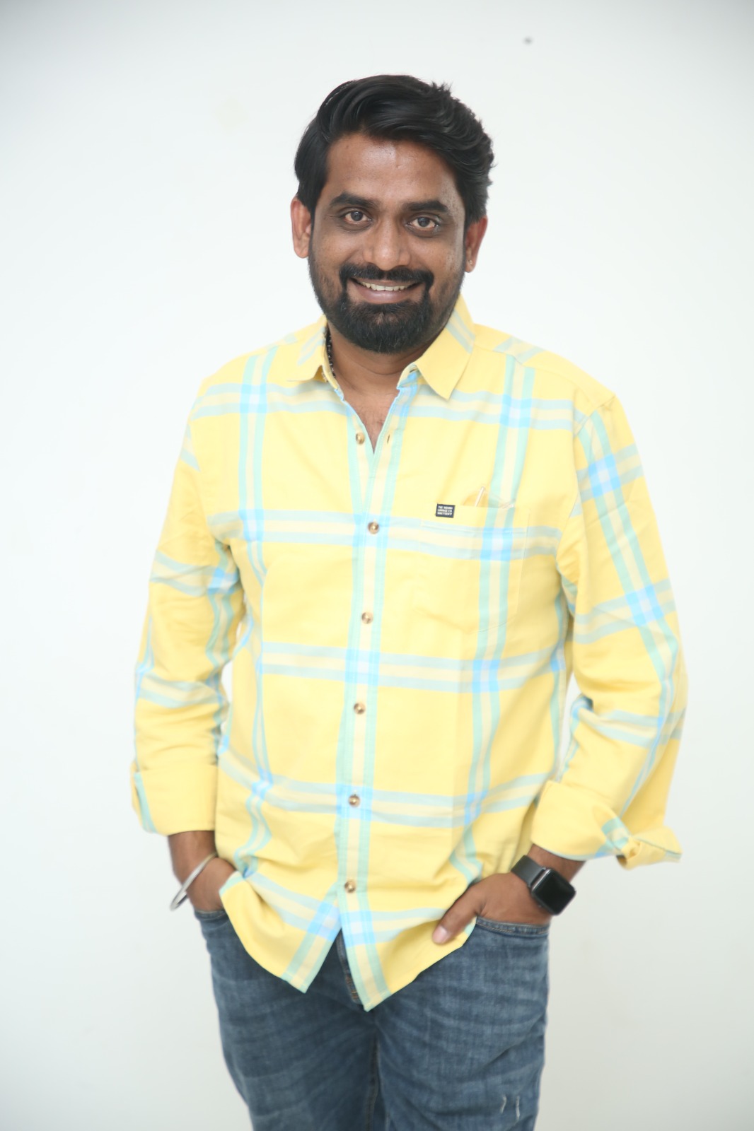 Gopi Atchara confident pose in bright plaid