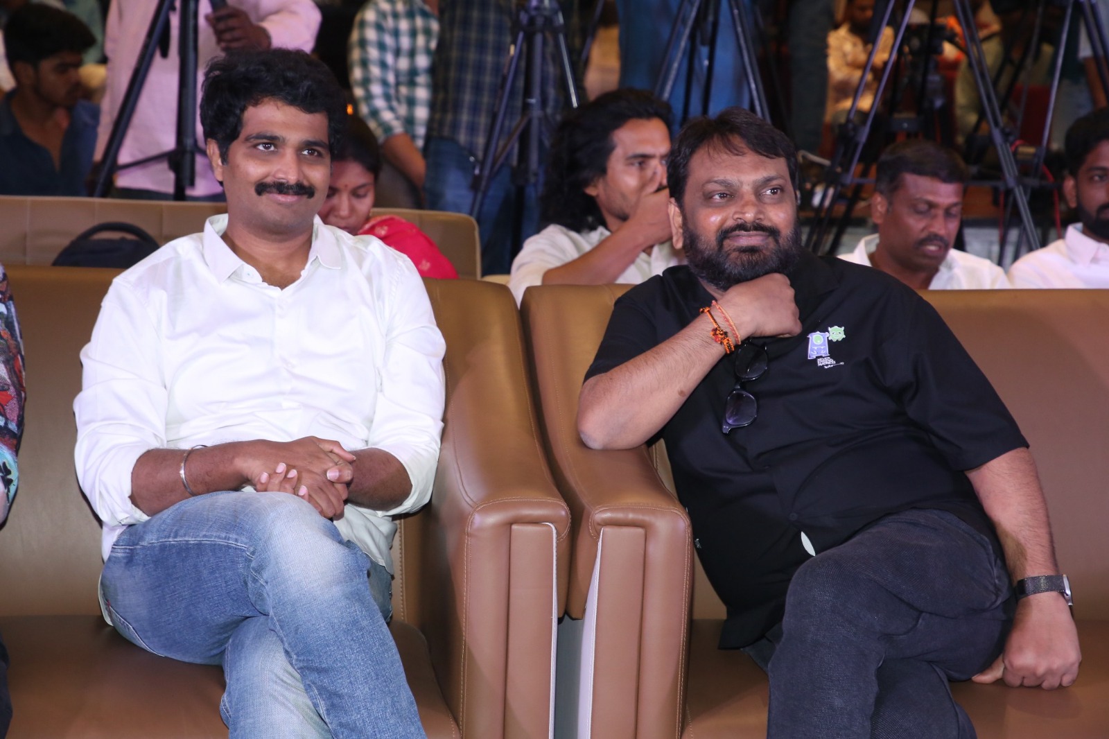 Producer Vamsi Nandipati seated at event