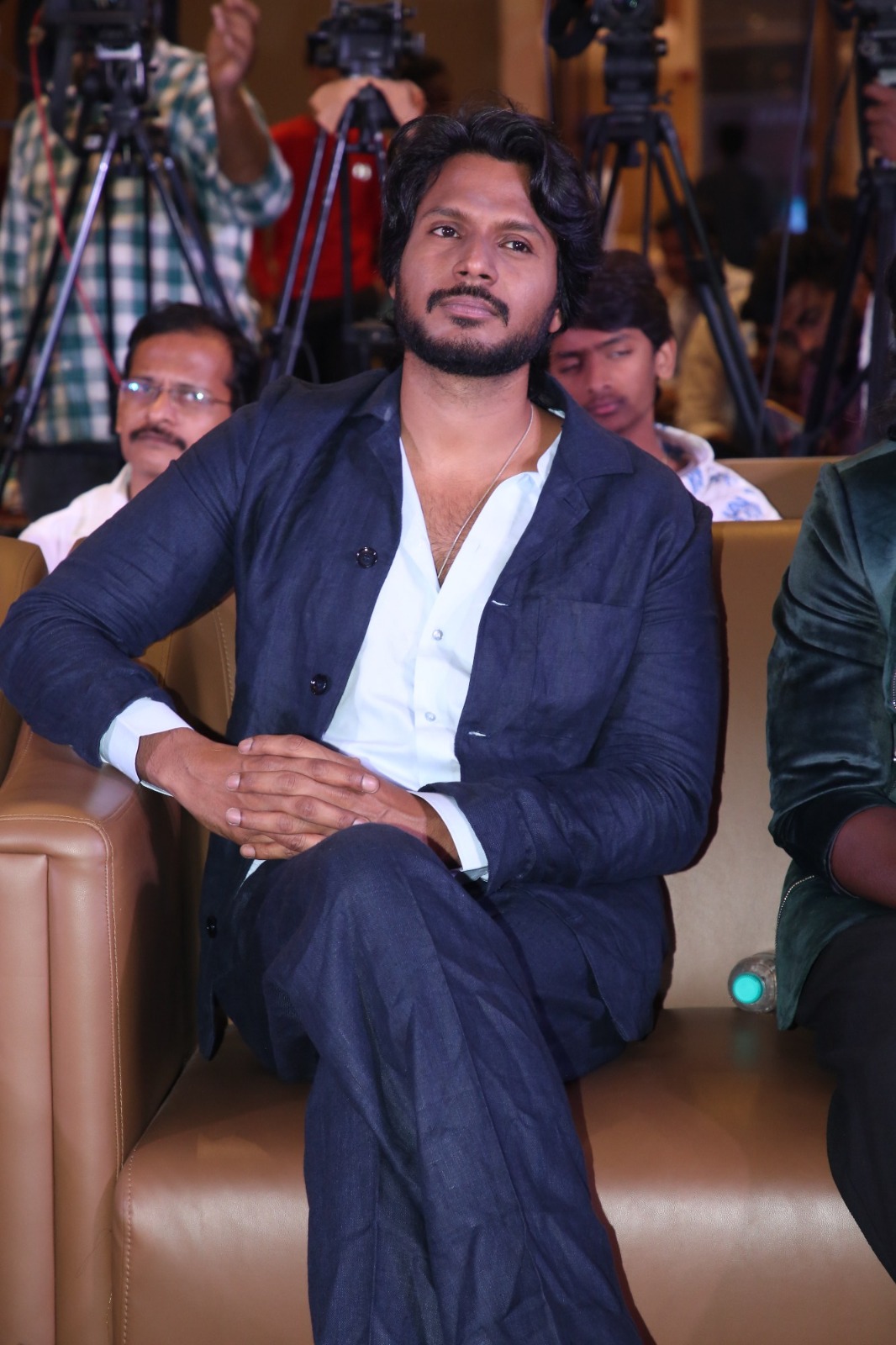 Sundeep Kishan seated at film event
